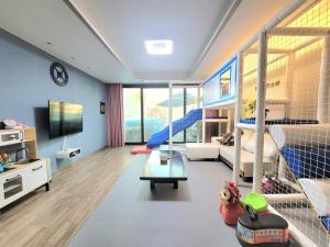 a childrens room with a bedroom with bunk beds at Geoje Theview Kids Poolvilla in Geoje