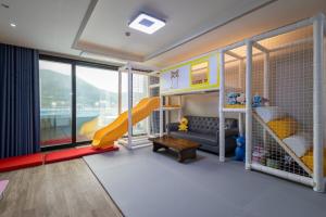 a childs room with a slide and a play area at Geoje Theview Kids Poolvilla in Geoje