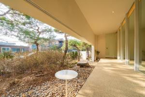 an external view of a building with a table on the sidewalk at Daebudo Space Pool Villa in Ansan