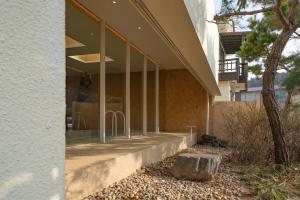 a building with a large window on the side of it at Daebudo Space Pool Villa in Ansan
