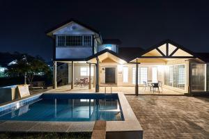 a house with a swimming pool in front of it at Daebudo Otier Pool Villa in Ansan