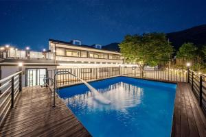 a swimming pool in front of a house at night at Gapyeong No 9 Number Nine Pension in Gapyeong