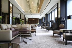 a lobby of a hotel with couches and tables at Solaria Nishitetsu Hotel Seoul Myeongdong in Seoul