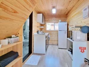 a small kitchen in a tiny house at Yanggu Byeolha Pension in Yanggu