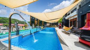 a swimming pool with a water fountain in a building at Gapyeong Casabella Pool Villa in Gapyeong +9 photos