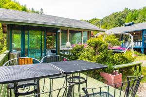 a patio with a table and chairs and a house at Pyeongchang Zermatt Pension Family, Couple in Pyeongchang 