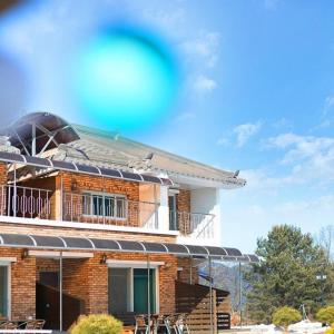 a building with a balcony and a frisbee in the air at Yanggu Dandelion Pension in Yanggu