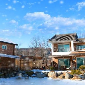 a house with snow in front of it at Yanggu Dandelion Pension in Yanggu