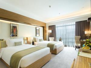 Postel nebo postele na pokoji v ubytování Greenleaf Hotel Gensan