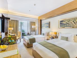 Postel nebo postele na pokoji v ubytování Greenleaf Hotel Gensan