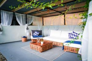 a tent with a bed and two chairs and a table at Apartamenty & SPA Villa 28 in Pobierowo