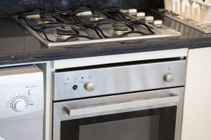 a stove top oven sitting in a kitchen at DIFC Luxury 1-Bed Apt with Stunning City Views in Dubai