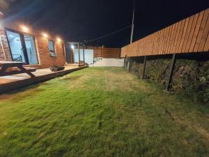 a backyard at night with a bench and a building at Guideok 1084 in Jeju