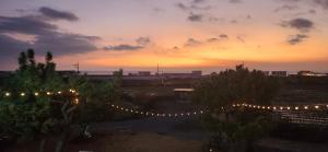 a view of a sunset with lights in a field at Seoguipo Deluna spa pension in Seogwipo
