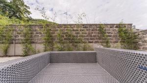 a brick wall with ivy growing on it at Yeosu Pyeongsari 85-7 Kids Pool Villa in Yeosu