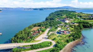 an aerial view of a small island in the water at Taean loghouse pension in Taean