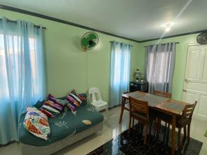 a living room with a couch and a table at 2 Storey House In Davao City Near Airport in Pampanga