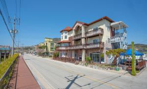 an empty street in a city with a building at Buan Bada Mudflat Pension in Buan