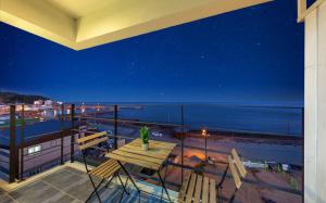 a balcony with a table and a view of the ocean at Yeongdeok Samsari Morning Pension in Yeongdeok