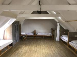 a room with two bunk beds in a attic at Le Rebond in Pommerit-le-Vicomte