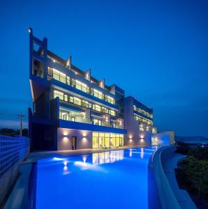 a large building with a swimming pool at night at Pohang Madame Annette Pool Villa dogs allowed in Pohang