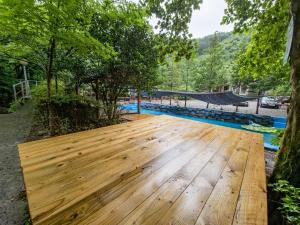 a wooden table in a yard with trees at Gwangyang Sukhee's Hwangto Pension in Gwangyang +13 photos