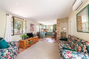 a living room with a couch and a table at Quinta Aida Cottage and B&B Suites in Lagoa