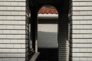 an opening in a brick building with a window at Stay Hyeopjae Soop in Jeju