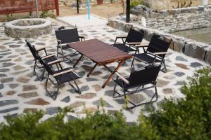 a wooden table and chairs on a patio at Nonsan Oyeo Poolvilla in Nonsan