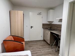 a small kitchen with a white door and a table at StayComfort24 in Osnabrück +32 photos