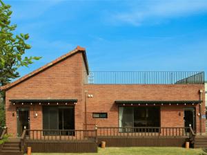 a brick building with a balcony in front of it at Jeju Dumo 542 in Jeju +10 photos