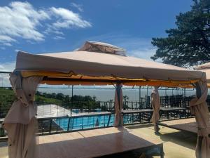 a large umbrella on a table near a pool at Road96 Caravan and Poolvilla in Yeonggwang +68 photos