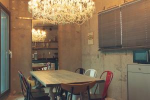 a dining room with a table and chairs and a chandelier at Jeju Blanc Jade Pool Villa in Seogwipo