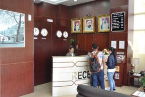 a group of people standing at a reception counter at Palette Top Stars Hotel in Abu Dhabi +16 photos