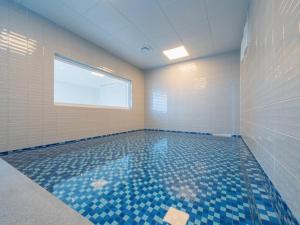 a room with a swimming pool with blue tiles at Pohang Pool Villa Yeongil in Pohang