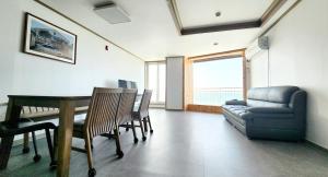 a living room with a table and chairs and a couch at Taean Chunmangeum in Taean