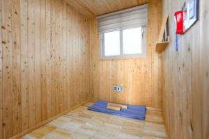 a room with a yoga mat in a wooden room at Gyeongju The Hidden Private Pool Villa in Gyeongju