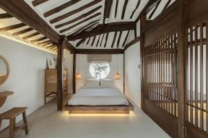 a bedroom with a bed in the middle of a room at Jeonju Leisure in Jeonju