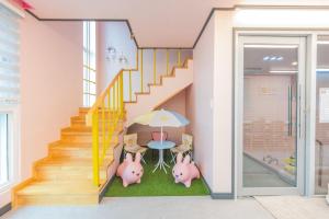 two pigs in a room with a staircase at Yeonhuijae Pool Villa Private Beomeo Branch in Yangsan