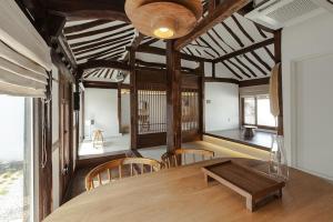 a dining room with a wooden table and chairs at Jeonju Leisure in Jeonju