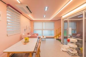 a room with a dining table and a living room at Yeonhuijae Pool Villa Private Beomeo Branch in Yangsan