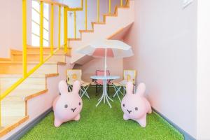 a house with two pinkomorphic rabbits in a room with stairs at Yeonhuijae Pool Villa Private Beomeo Branch in Yangsan