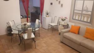 Una sala de estar con un sofá, una mesa y sillas. en Casa Boss Oblivium, en Florencia