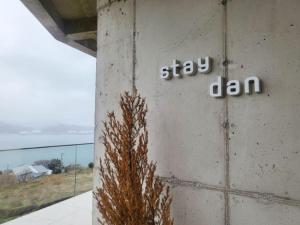 a building with the words stay lan written on it at Namhae Staydan Pool Villa in Namhae