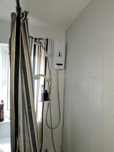 a shower in the corner of a room at Nicks place in Peterborough