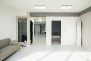 a living room with a couch and a bed in it at Yeosu Haeandang in Yeosu