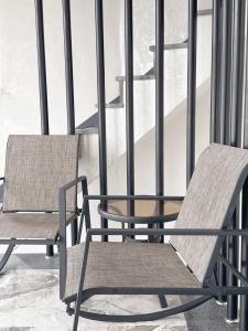 two chairs and a table on a balcony at Yeosu Bamview Stay in Yeosu