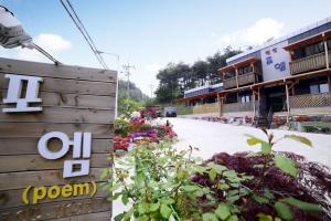 a building with a sign on the side of a street at Poem Pension in Incheon