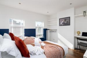 a living room with a couch with pillows at Spacious & Charming 2BR - Perfect Stay in Northampton