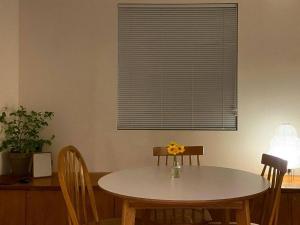 a table and chairs in a room with a window at Suncheon Stay Rev in Suncheon